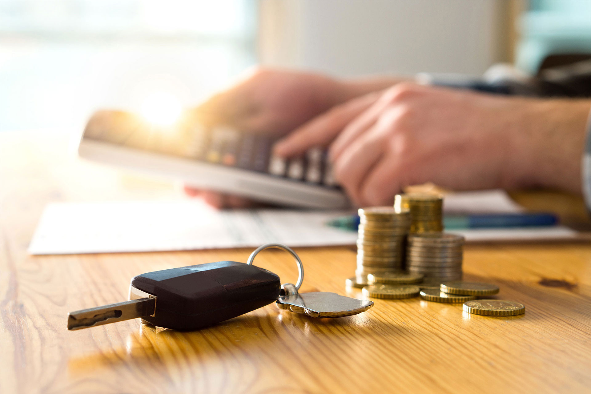 Car Key Next to Coins Article Hero Background