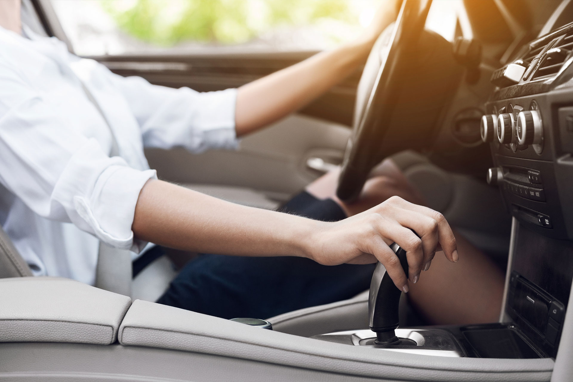 Hand on Gear Shift Article Hero Background